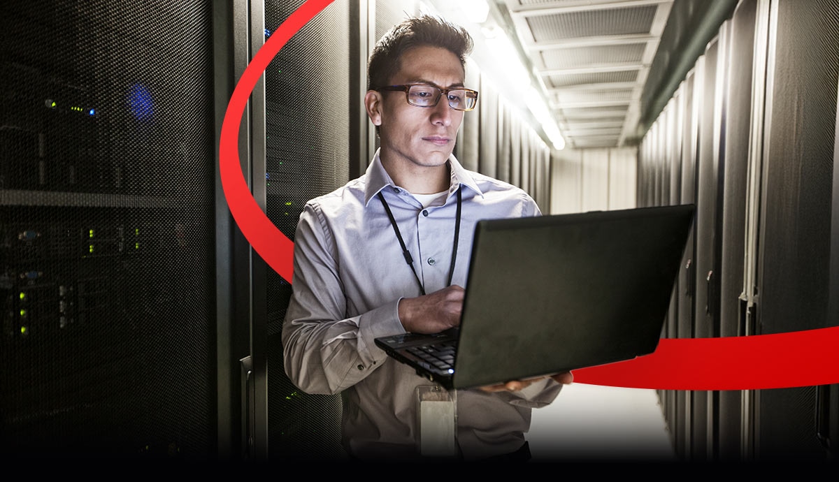 Network engineer monitoring server racks to strengthen cyber resilience and automate compliance for financial institutions.