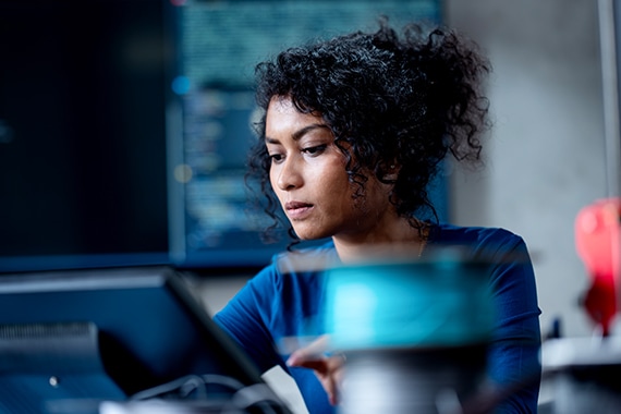 thumbnail image of an IT specialist working on a laptop computer for cybersecurity