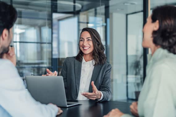 Cybersecurity consultant collaborating with business team to design scalable security solutions in modern office setting