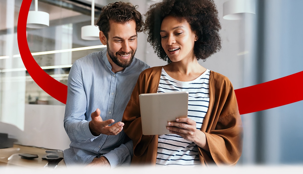 Two coworkers collaborating on a tablet.