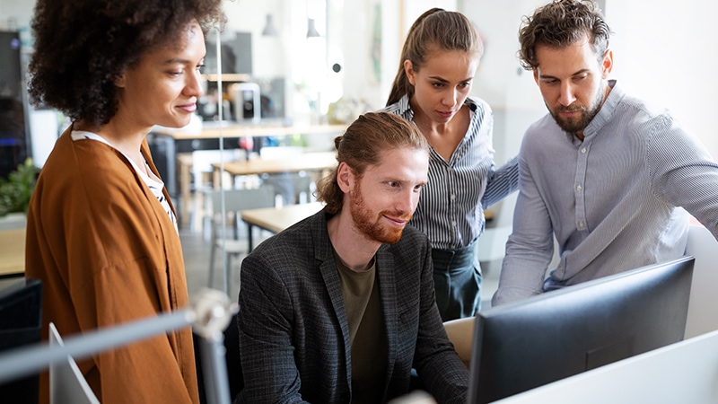 Team reviewing data privacy work together in office.