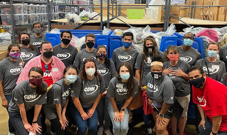 Chicago-based CDW coworkers pose in front of blue donation bins