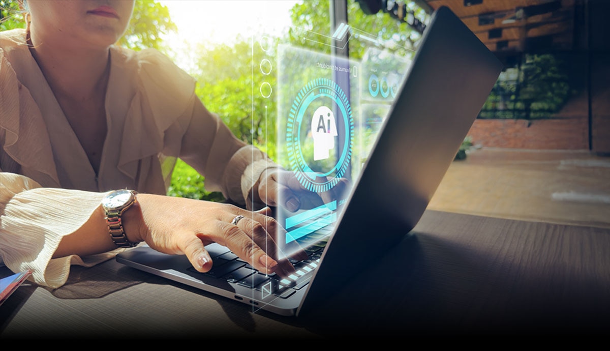 Person using a laptop with futuristic AI interface graphics, representing organization-wide artificial intelligence success.