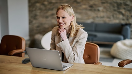 thumbnail image of a woman working on a Dell laptop inside an office