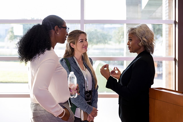 Guest speaker talking with government employees.