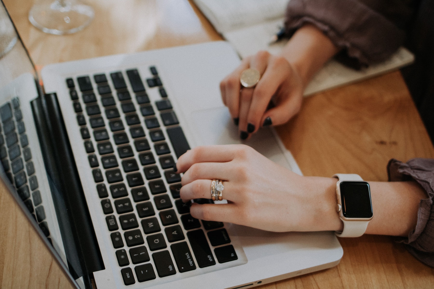 Lady typing on a laptop, while working from home.