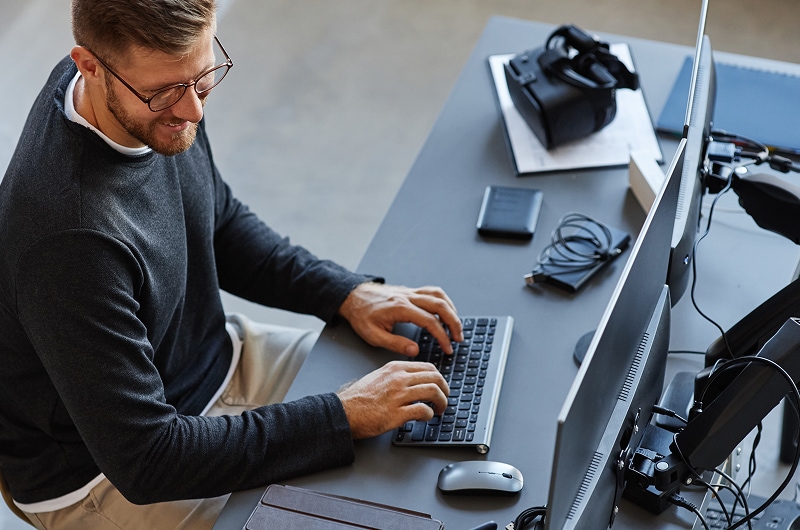 IT professional focused at workstation.
