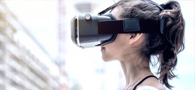 Brunette woman wearing a VR headset outside