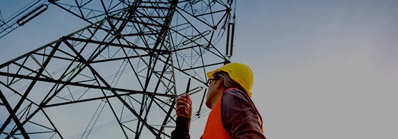 person looking at a grid tower