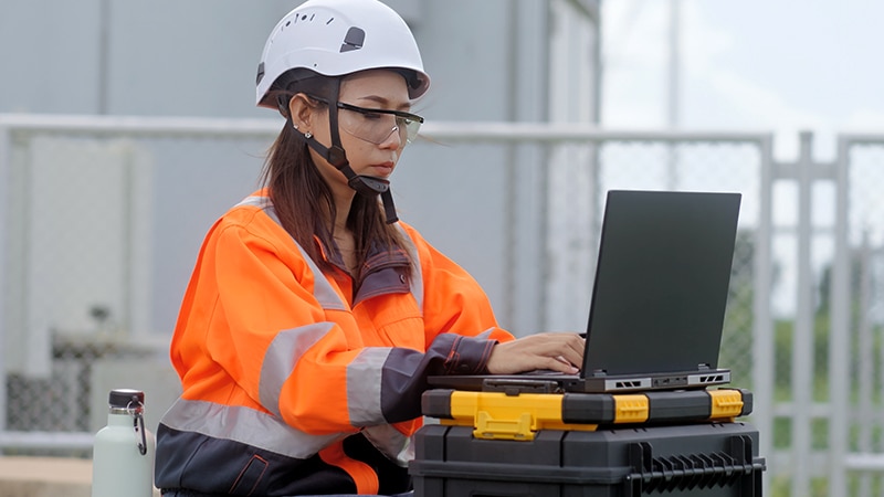 Person using laptop outside.