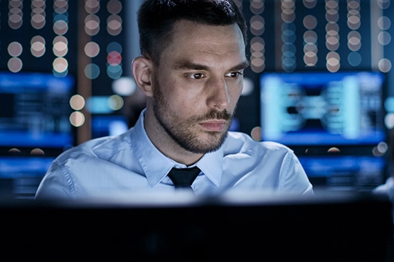 Government employee working on computer in data center.