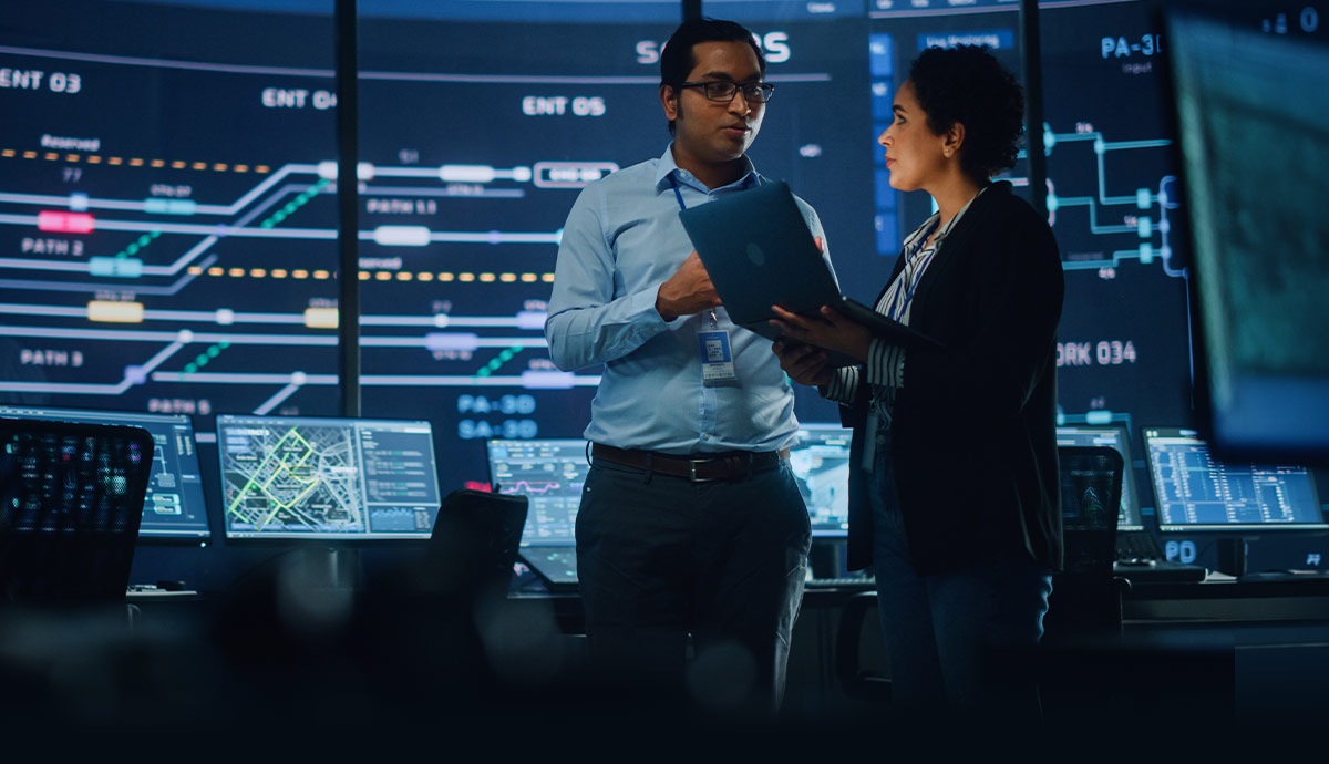 Federal engineering professionals collaborating in a technology operations center supporting integrated services, systems engineering, and mission‑critical government programs.