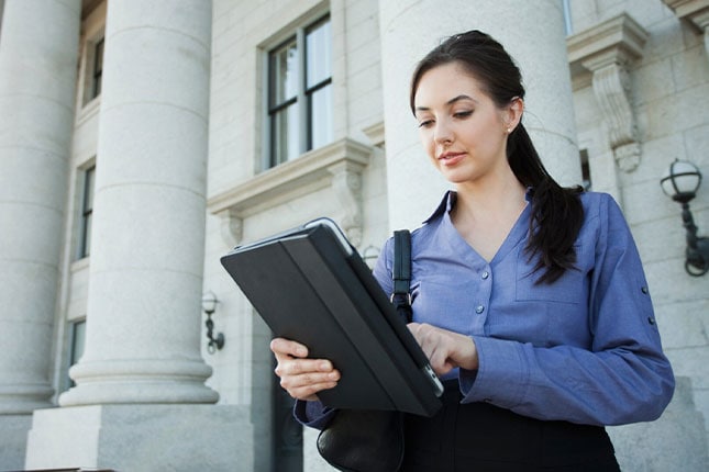 Businesswoman using digital tablet outdoors
