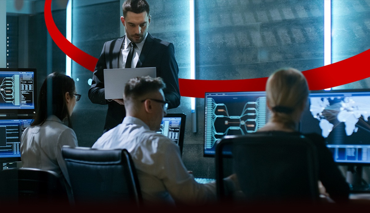 IT team in dark room reviewing network data.