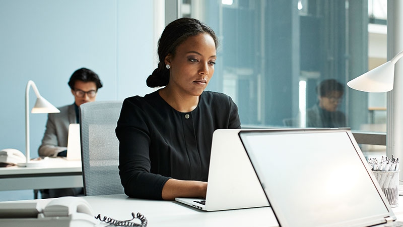 Woman using laptop in a bright modern office.