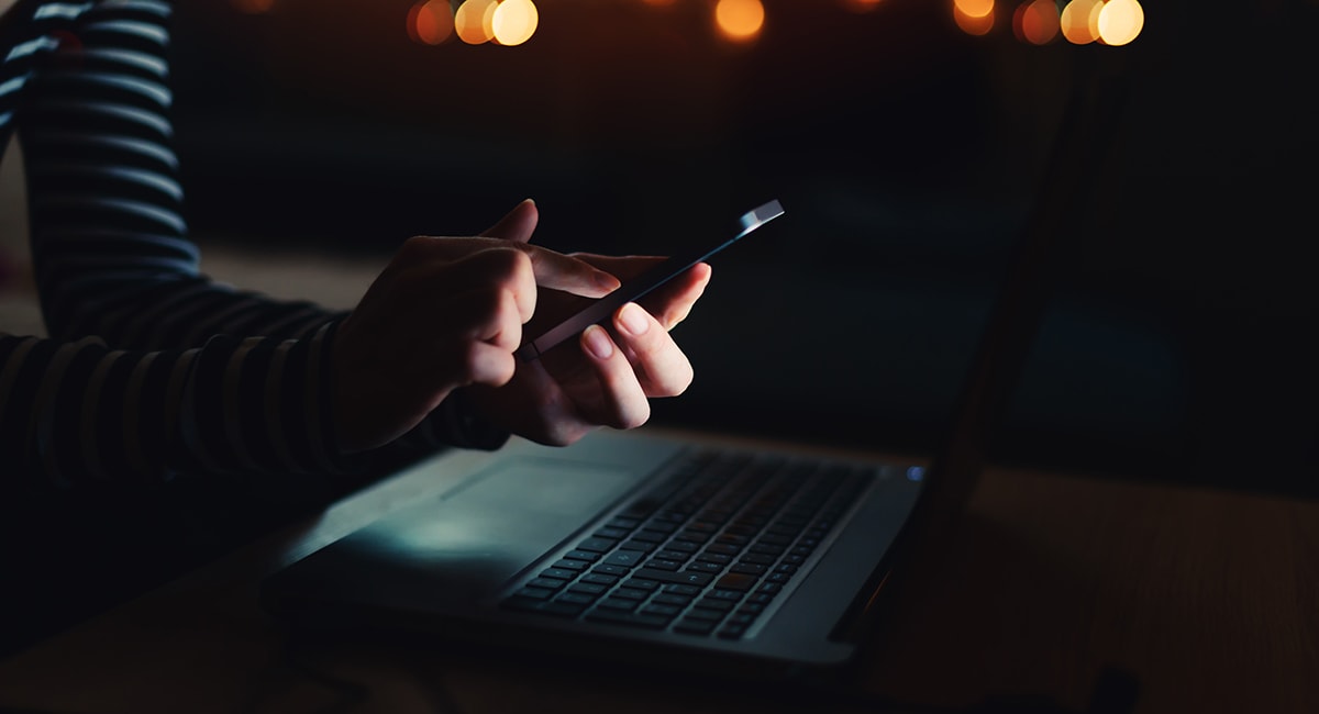 Person using their phone in the dark