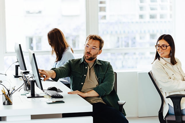 Employees collaborating in a modern workspace, showcasing how Agentspace empowers teams to streamline workflows, enhance communication, and boost productivity.