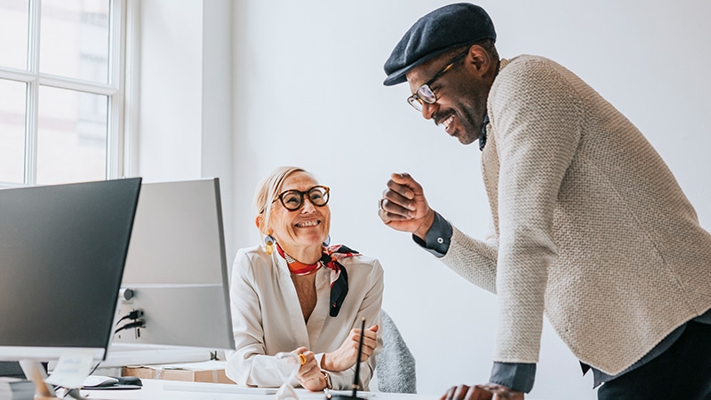 image of two coworkers collaborating in an office setting