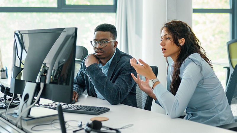 Coworkers collaborating in bright office
