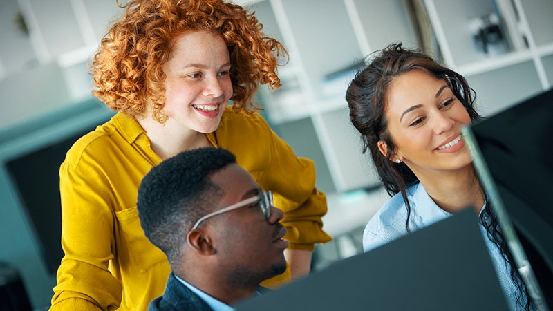 Coworkers in bright office exploring Google Workspace
