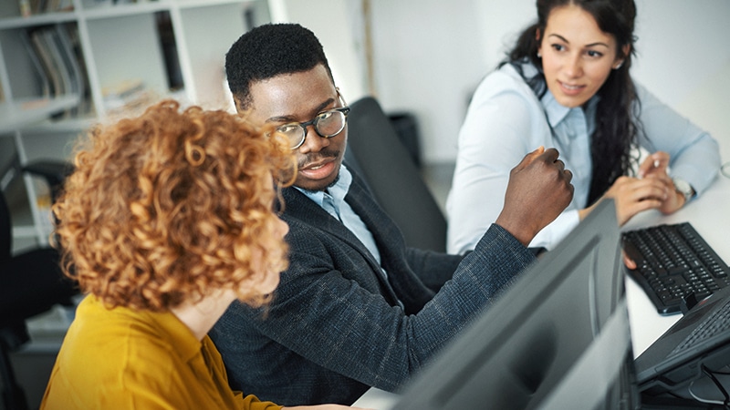 Coworkers in office using Google Workspace