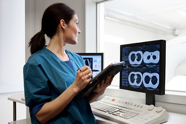 Nurse reviewing MRI scans.
