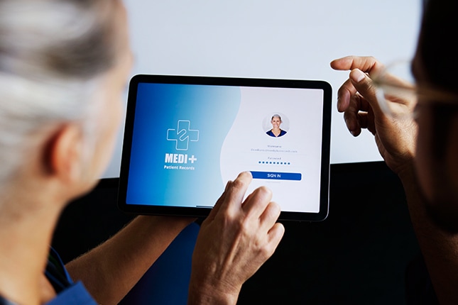 Doctor showing patient online healthcare in a tablet.