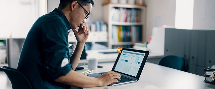 Mid adult man working on his personal finance in his jewelry work shop