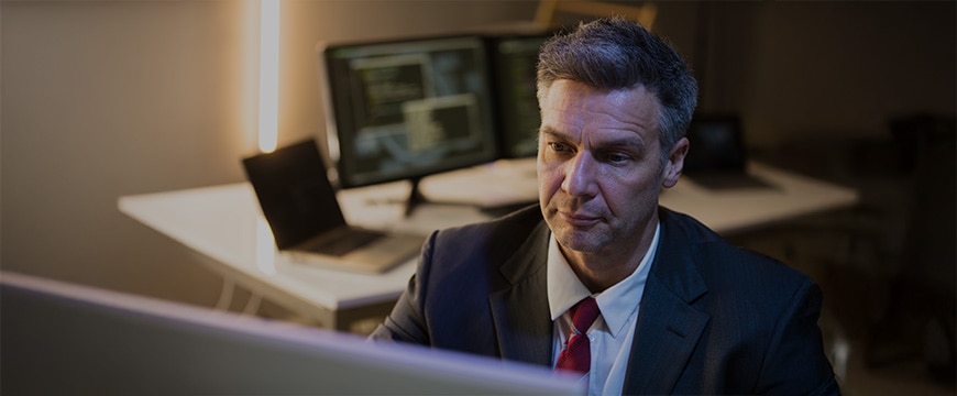 Close-up Of A Mature Businessman Working On Computer