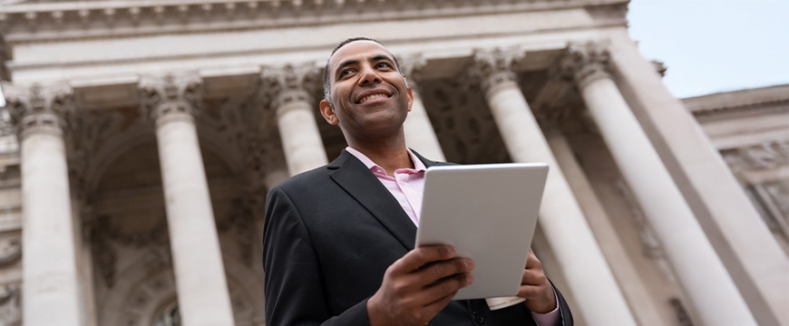 Successful business man using a tablet computer outdoors