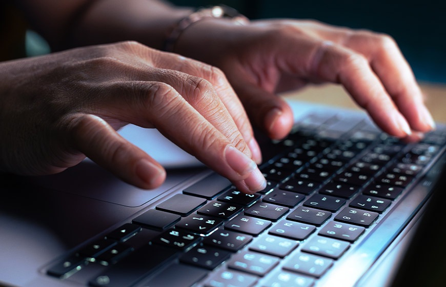 programmer hand using laptop