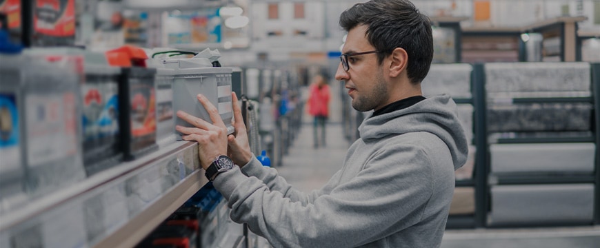 Smart male customer buying car battery