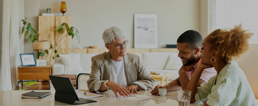 Female finance advisor explaining a diverse couple