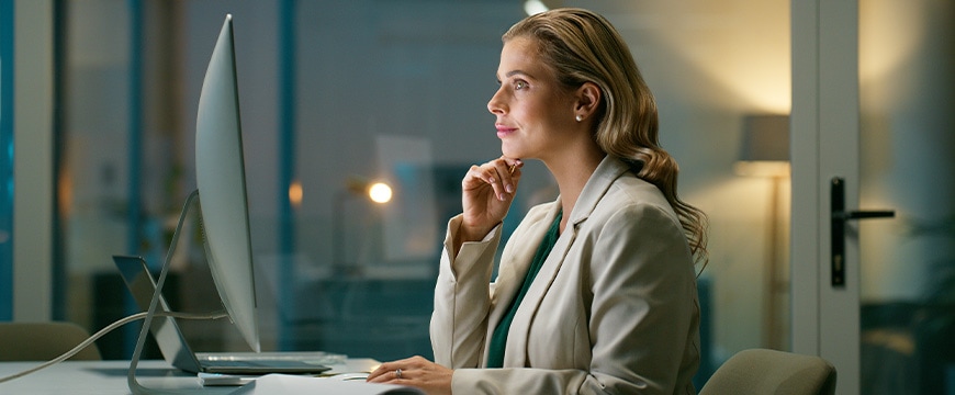 Thinking, reading and business woman with computer for planning or financial insight at night. Problem solving, tech and accountant check email for budget, investment or idea on deadline in office