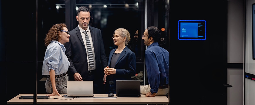 Finance professionals talking in meeting room.