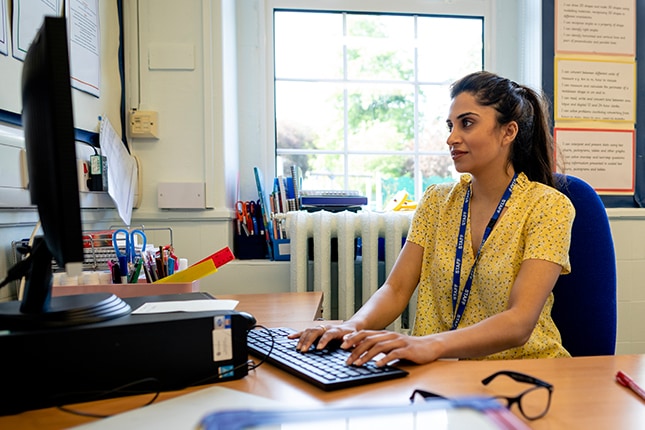 Teacher working on computer from her office.