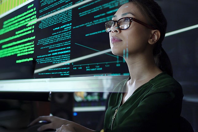 Woman working on computer analyzing data.