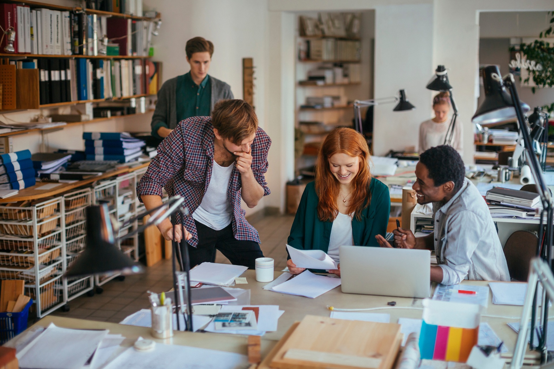 People sitting in an artist studio collaborating and working.