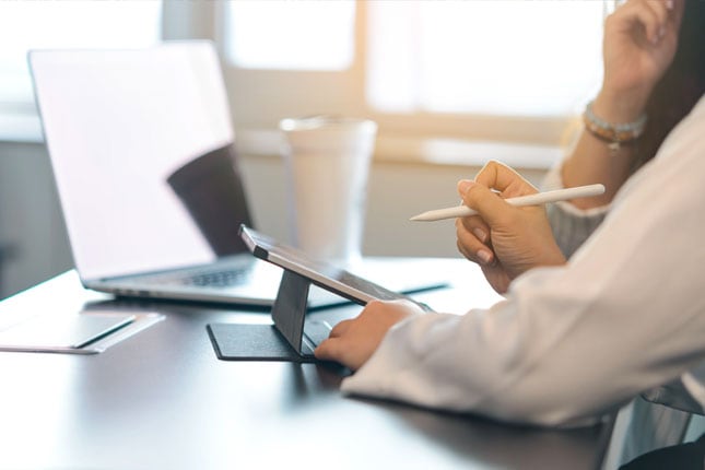 People looking at monitor in outdoor office setting