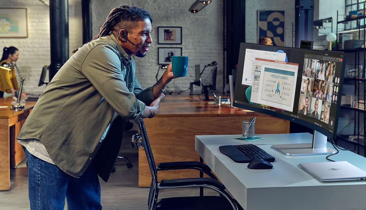 Person in modern office using HP accessories and displays.