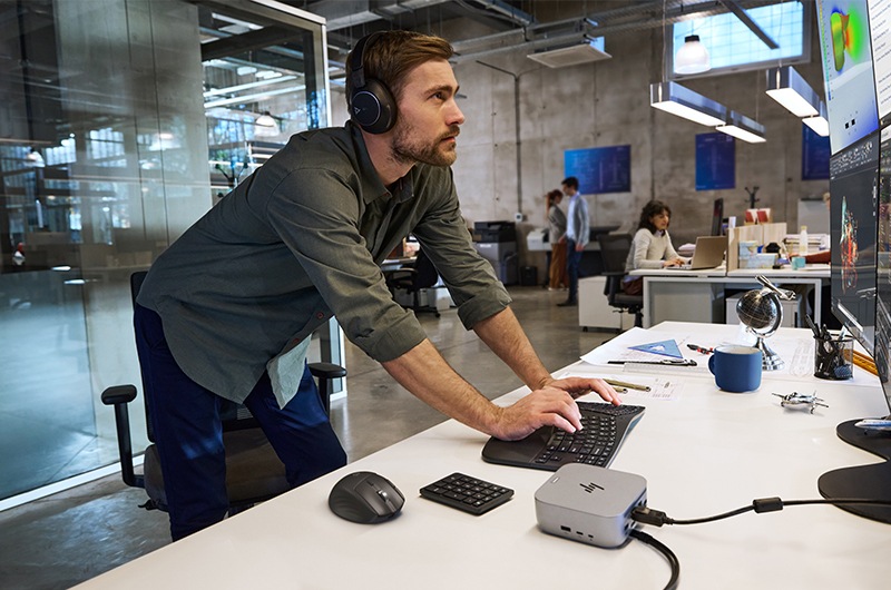 Lifestyle image of a man in an office using HP products and accessories