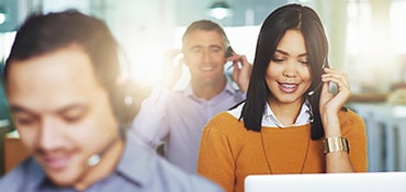 Employees answering phones in a call center