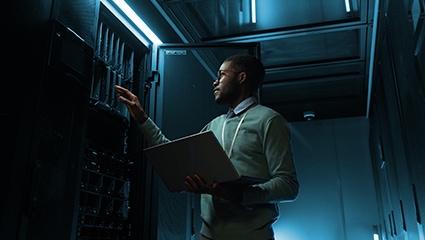 thumbnail image of an IT specialist working in a data center server room