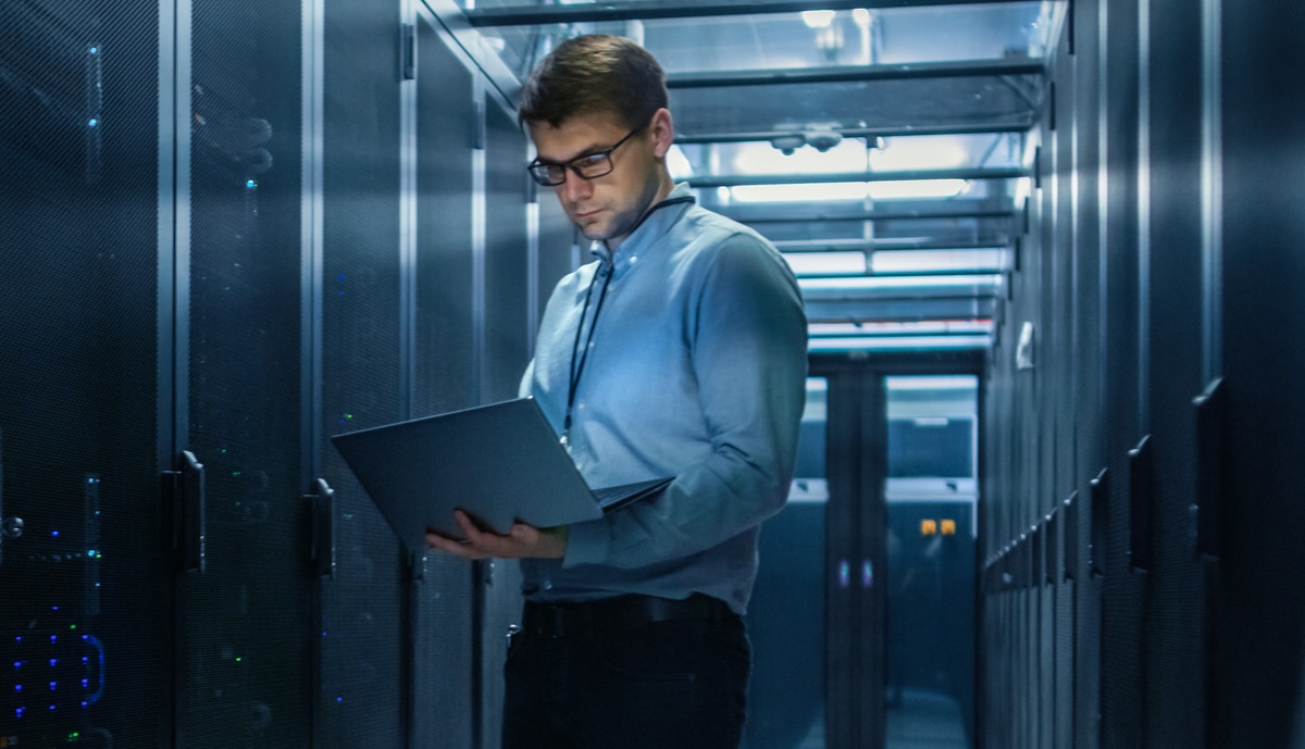 hero image of an IT specialist inside a data center server room