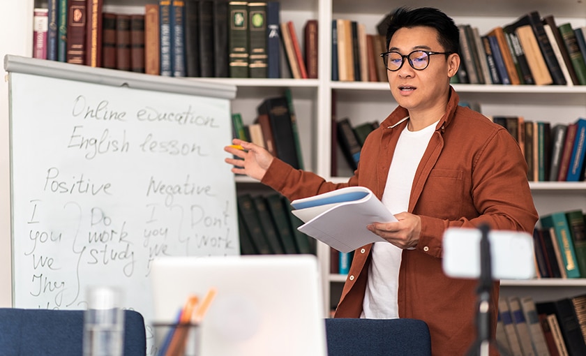 image of a man remote teaching from his classroom via laptop computer