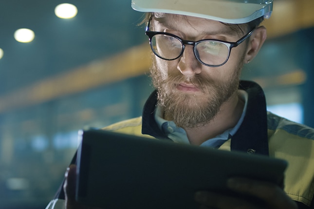 image of a man in a hardhat working on a tablet device