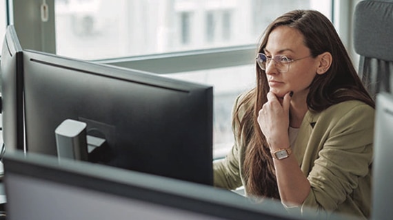 Woman using computer in a bright office.