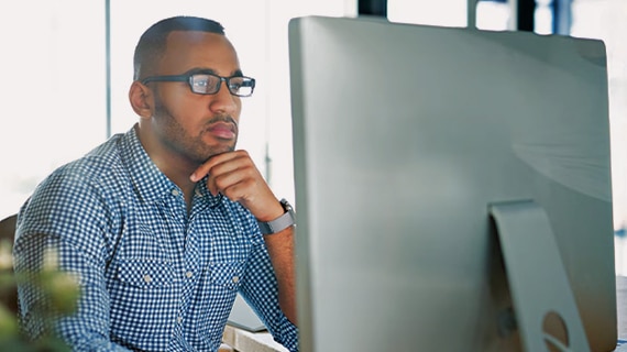 Man using computer remotely at home.