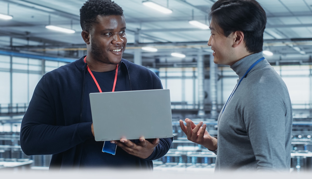 Two IT specialists working in a data center.