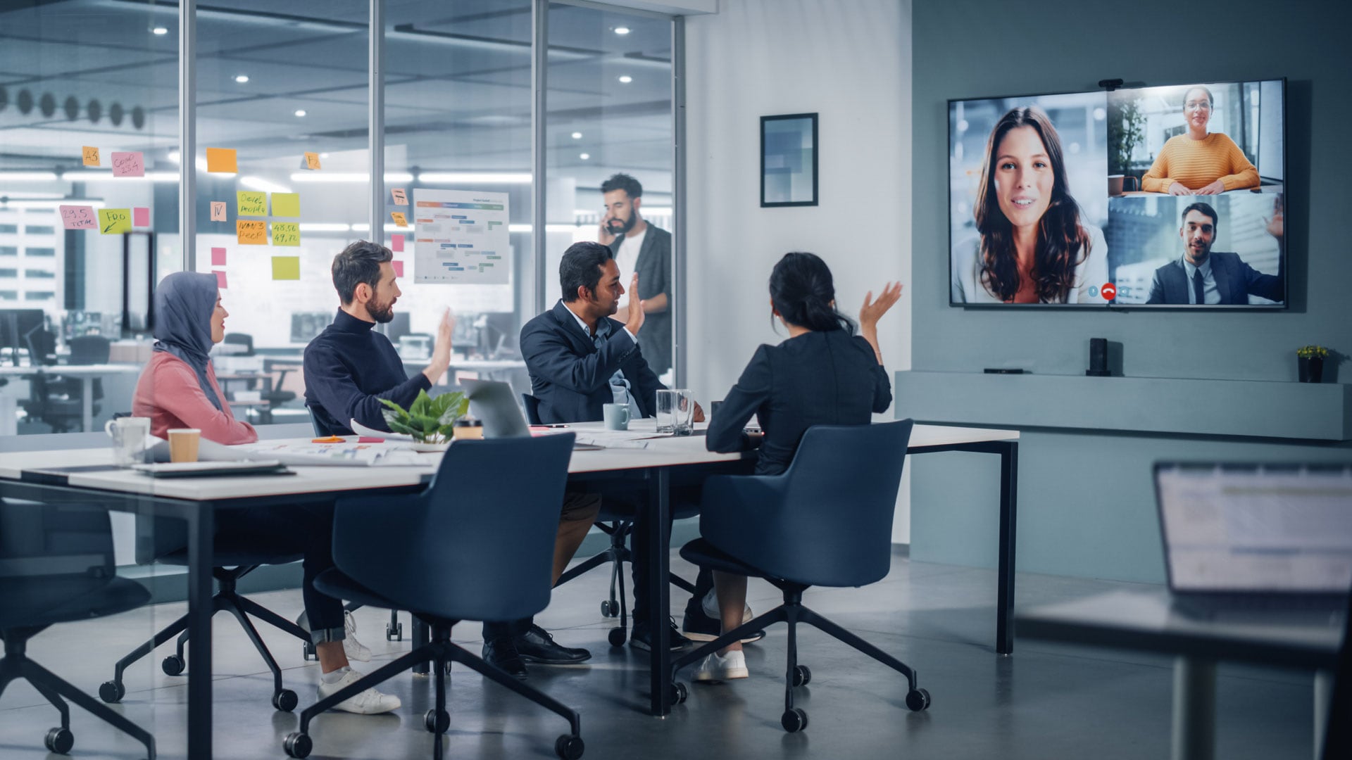 People are sitting in an office attending an Hybrid meeting